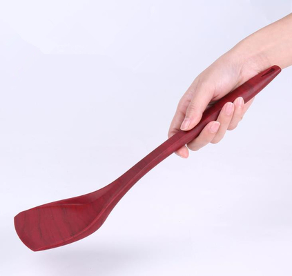 Le grain en bois dénomme le silicone Turner de catégorie comestible faisant cuire des outils pour la casserole antiadhésive